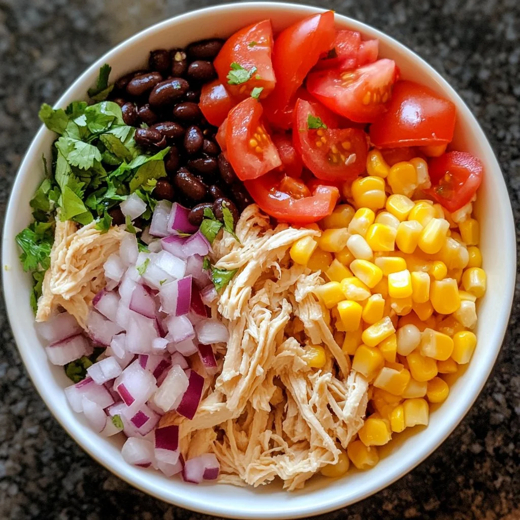 A vibrant bowl of quick Southwest chicken salad with colorful vegetables and toppings