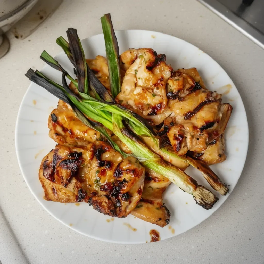 Plate of flavorful Vietnamese Grilled Chicken served with fresh herbs and dipping sauce