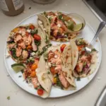 Delicious blackened salmon tacos garnished with fresh toppings.