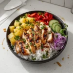 Hawaiian Chicken Bowl with chicken, vegetables, and sauce.