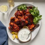 Delicious Honey Harissa Chicken garnished with herbs