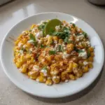 Bowl of Mexican Street Corn topped with cheese and spices