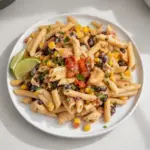 One Pot Southwest Chicken Pasta dish served in a bowl with colorful ingredients.